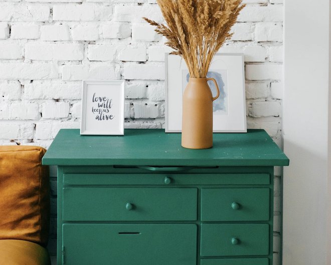 green table with a flower vase on it